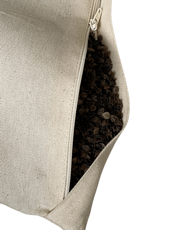 Open zip buckwheat pillow end showing the buckwheat hulls within